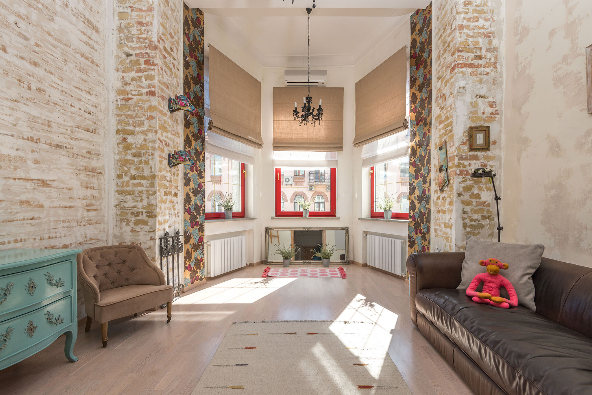 Salon loftowy z aneksem, ceglaną ścianą i drewnem